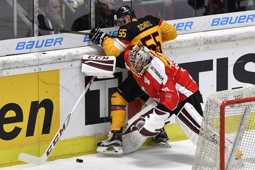 Switzerland’s goalkeeper Rober Mayer, right, fights for the puck against Germany’s Felix Schuetz during the Ice Hockey Deutschland Cup at the Curt-Frenzel-Eisstadion in Augsburg, Germany, Saturday, No ...