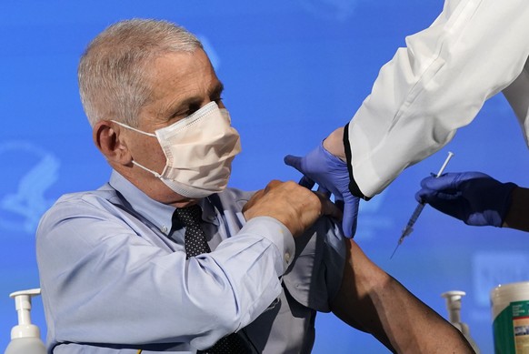 FILE - In this Dec. 22, 2020, file photo, Dr. Anthony Fauci, director of the National Institute of Allergy and Infectious Diseases, prepares to receive his first dose of the COVID-19 vaccine at the Na ...
