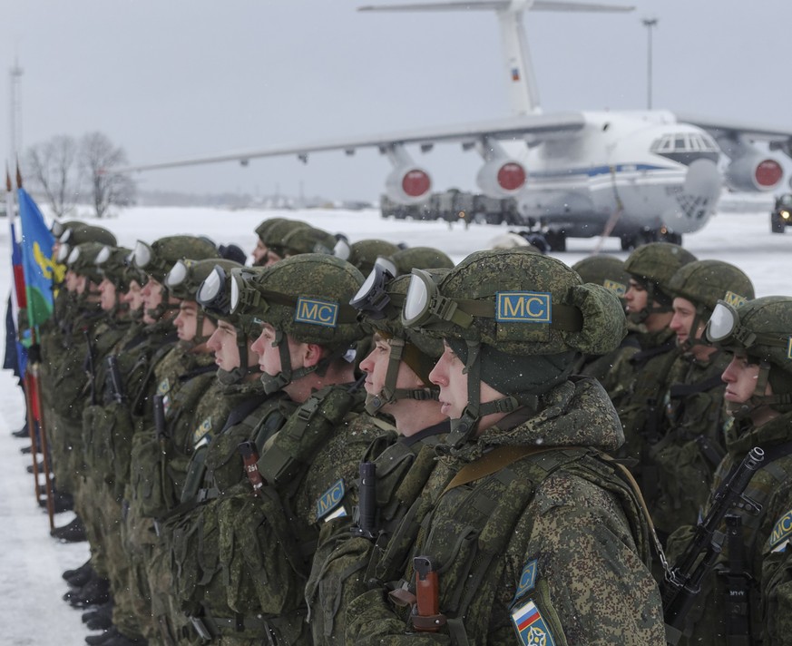 epa09688021 A handout photo made available by the Russian Defence Ministry press service shows Russian peacekeepers attending a welcome ceremony upon returning from a mission in Kazakhstan on the mili ...