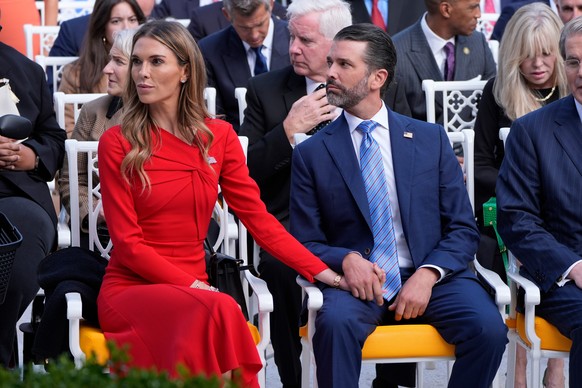 Donald Trump Jr. sits with his partner Bettina Anderson before a ceremony to present the Presidential Medal of Freedom for Charlie Kirk to his widow Erika Kirk in the Rose Garden of the White House, T ...