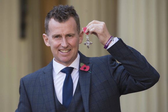 Rugby referee Nigel Owens poses with his MBE which he received from the Duke of Cambridge at Buckingham Palace in London, Britain November 11, 2016. REUTERS/Stefan Rousseau/Pool