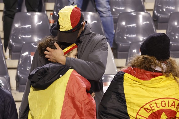 A supporter is comforted in the stands after the suspension of the European Championship 2024 qualifying match in Group F between Belgium and Sweden at the King Baudouin Stadium in Brussels, Monday, October 8.  16, 2023. The...