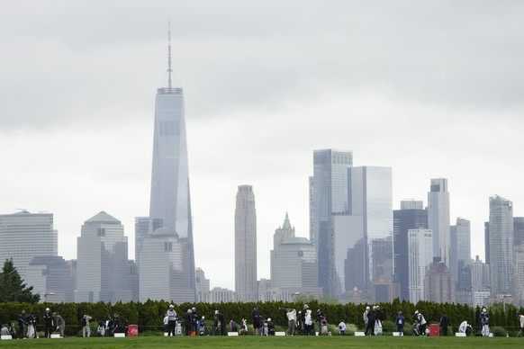 Golfers warm-up on the driving range in front of the New York City skyline during the first round of the Mizuho Americas Open golf tournament, Thursday, May 16, 2024, in Jersey City, N.J. (AP Photo/Se ...