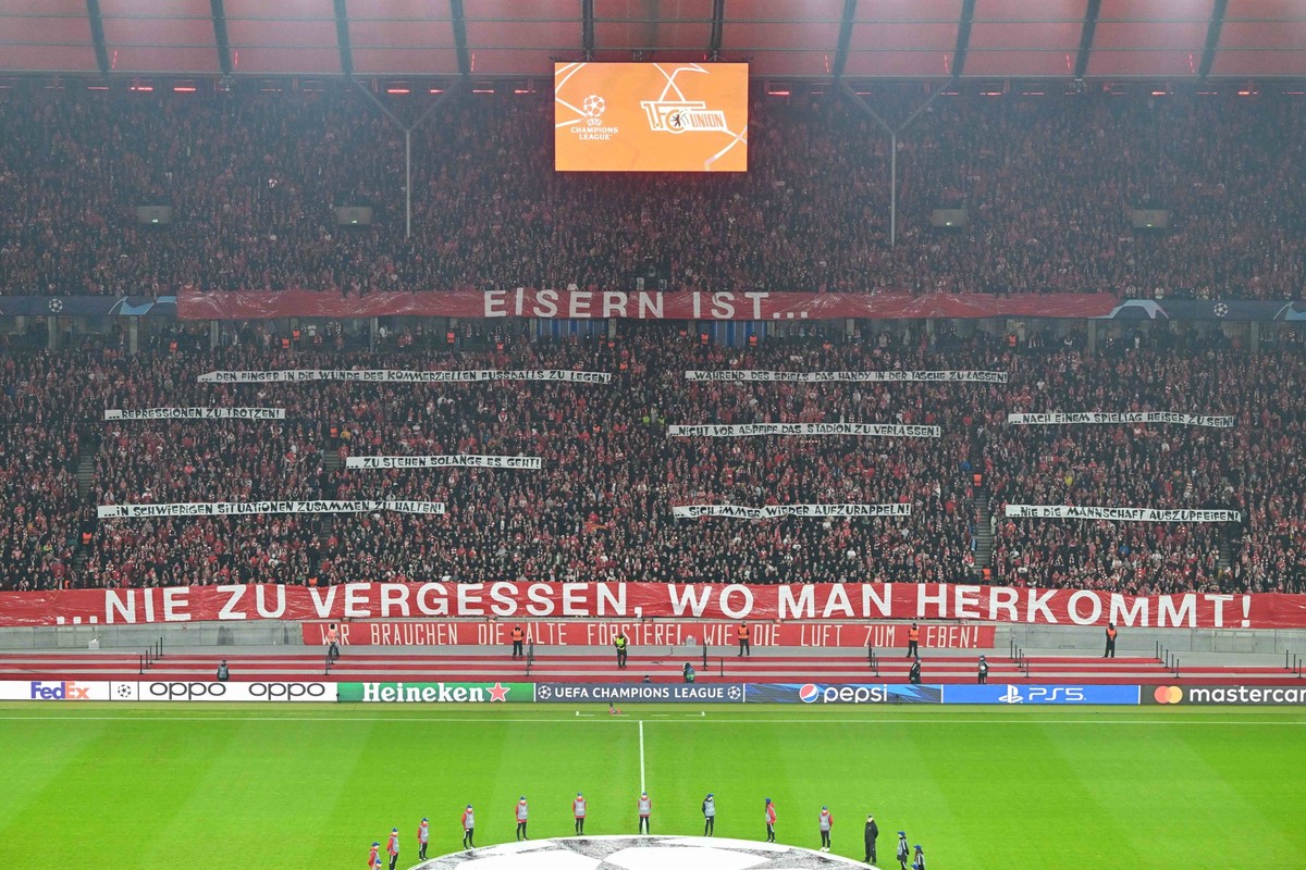Fussball, Herren, Saison 2023/2024, UEFA Champions League Gruppe C, 3. Spieltag, 1. FC Union Berlin - SSC Neapel, v. l. Die Fans von 1. FC Union Berlin mit einem Spruchband: Eisern ist . nie zu verges ...