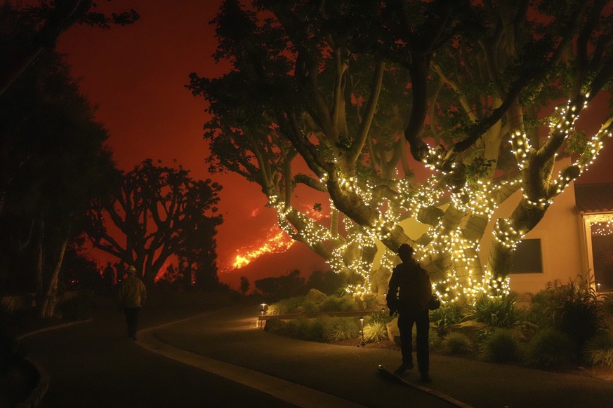 Firefighters monitor the Franklin Fire approaching Pepperdine University in Malibu, Calif., Tuesday, Dec. 10, 2024. (AP Photo/Jae C. Hong)