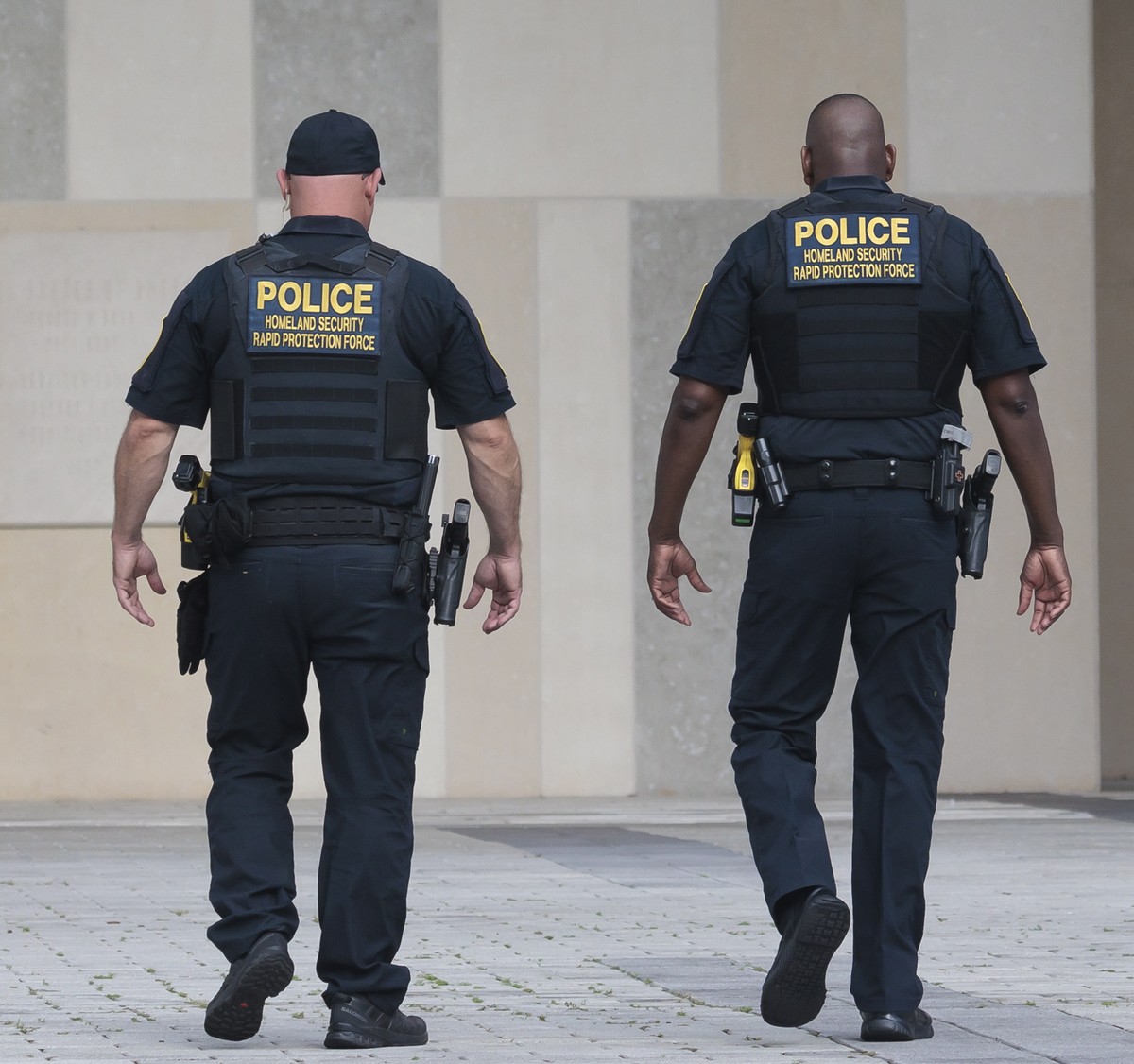 epa10686789 Police officers on the grounds of the Wilkie D. Ferguson United States Courthouse, where former US President Donald Trump is scheduled to surrender to federal authorities on 13 June, in Mi ...