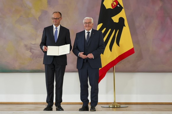 epa12077932 Newly appointed German Chancellor Friedrich Merz (L) receives his certificate of appontment from German President Frank-Walter Steinmeier (R) during the appointment of the Federal Chancell ...