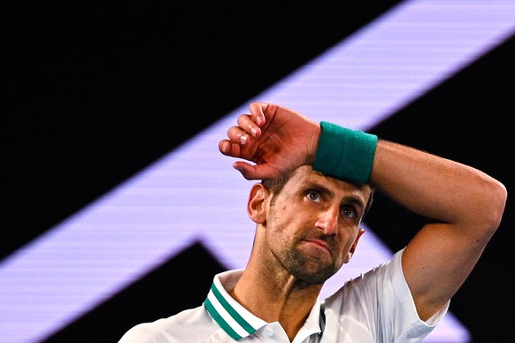 epa09011754 Novak Djokovic of Serbia reacts during his men&#039;s singles fourth round match against Milos Raonic of Canada at the Australian Open Grand Slam tennis tournament at Melbourne Park in Mel ...