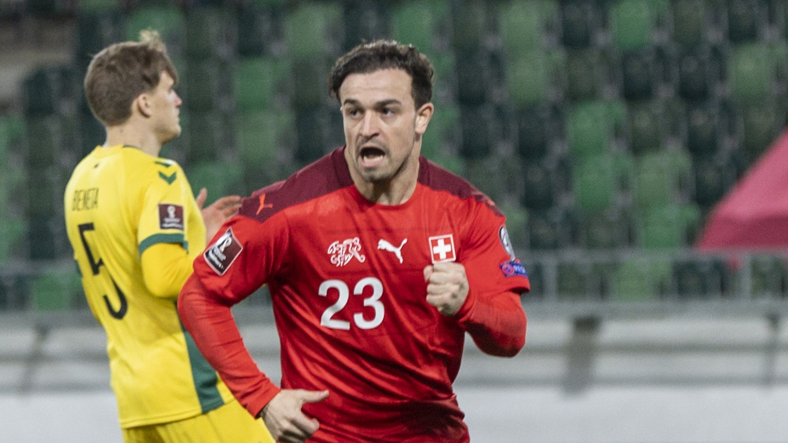 Switzerland&#039;s Xherdan Shaqiri, center, celebrates after scoring to 1:0 between Lithuania&#039;s Markas Beneta, left, and Martynas Dapkus during the FIFA World Cup Qatar 2022 qualifying Group C so ...