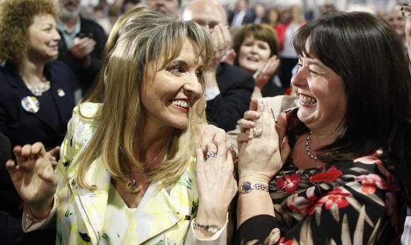 Sinn Fein&#039;s Martina Anderson, left, celebrates with Michelle Gildernew at the Kings Hall count centre, Belfast, Northern Ireland, Monday, May, 26, 2014. Sinn FÈin&#039;s Martina Anderson has topp ...