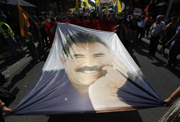 Kurdish protesters of the Yazidis ethnic minority hold a banner of Abdullah Oecalan during a demonstration in Frankfurt August 9, 2014. Some 2,000 ethnic Kurds of the Yazidis sect, who practice an anc ...