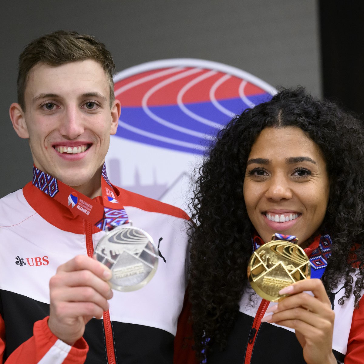 epa09837464 Simon Ehammer of Switzerland, silver medalist of the Men's Heptathlon (L) and Mujinga Kambundji of Switzerland, gold medalist of the Women's 60 Metres, pose at the IAAF World Ath ...