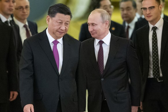 FILE - Chinese President Xi Jinping, center left, and Russian President Vladimir Putin, center right, enter a hall for talks in the Kremlin in Moscow, Russia, June 5, 2019. Russia and China have forge ...