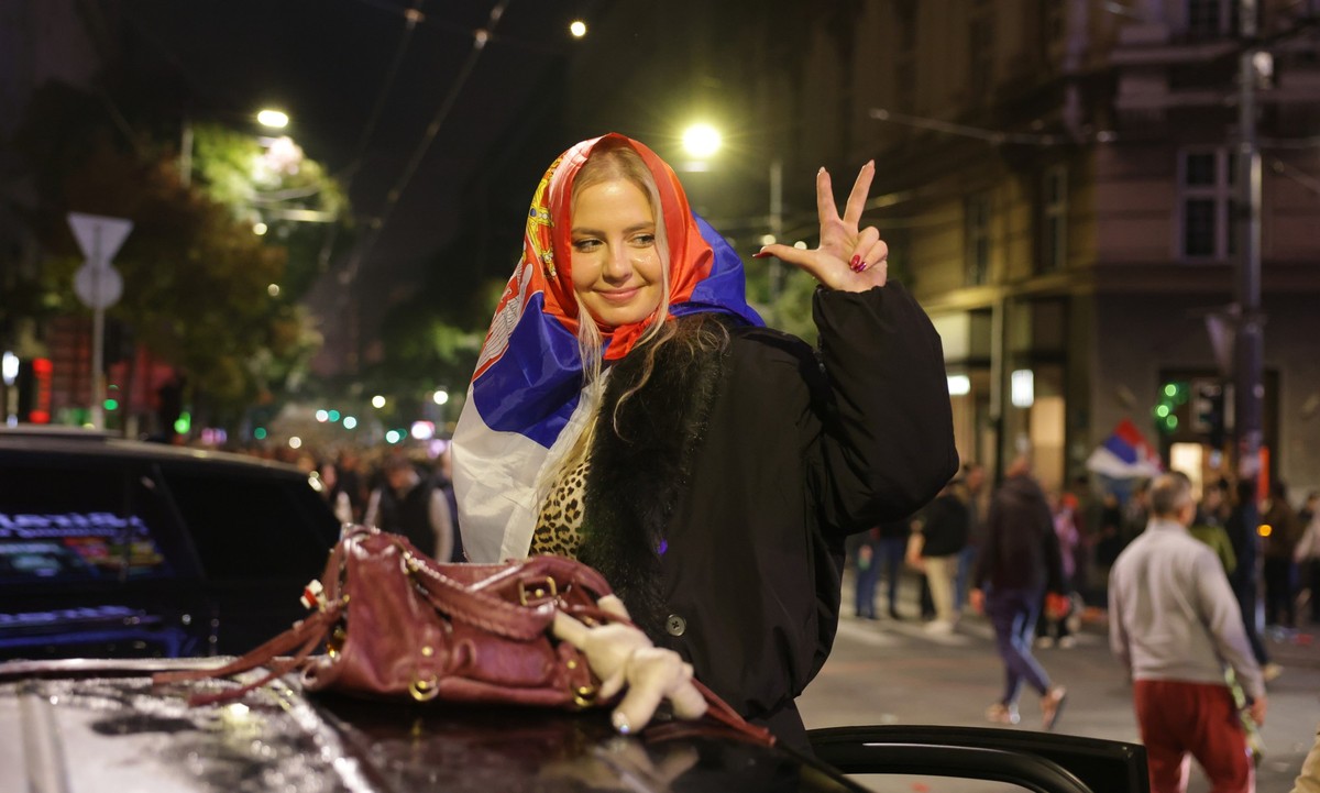epa13331984 A supporter of the 'Student List' celebrates after the parliamentary elections in Belgrade, Serbia, 25 October 2026. Roughly 6.5 million eligible voters were called to the polls  ...