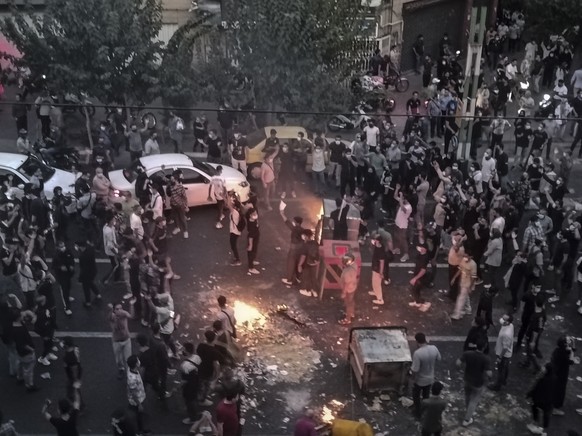 FILE - Iranians protest a 22-year-old woman Mahsa Amini&#039;s death after she was detained by the morality police, in Tehran, Sept. 20, 2022, in this photo taken by an individual not employed by the  ...