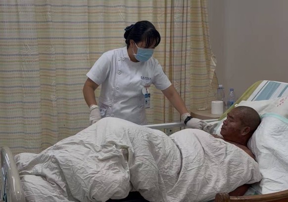 260607 -- CHENGMAI, June 7, 2026 -- A medical worker takes care of Qin Jianping at Chengmai County People s Hospital in Chengmai County, south China s Hainan Province, June 6, 2026. TO GO WITH China F ...