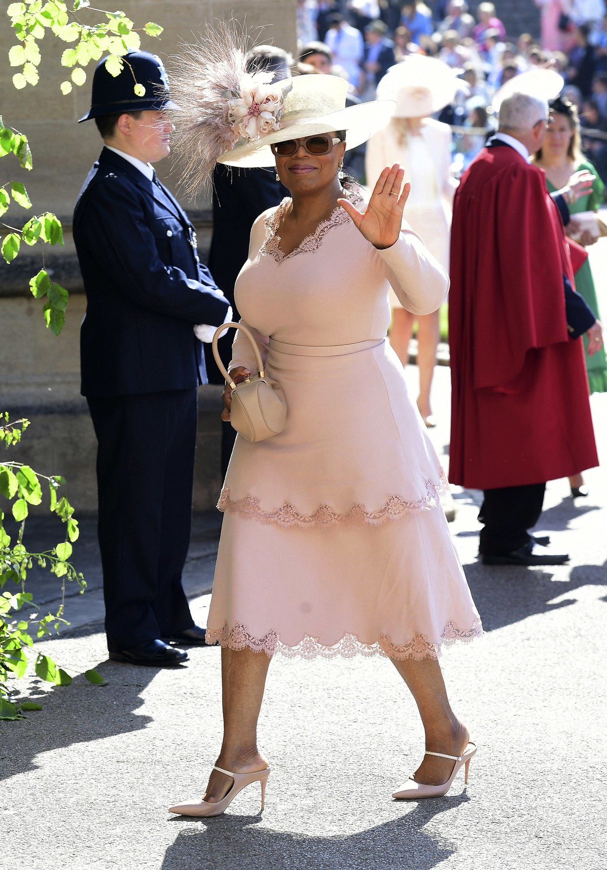 Oprah Winfrey waves as she arrives at St George's Chapel at Windsor Castle the wedding ceremony of Prince Harry and Meghan Markle at St. George's Chapel in Windsor Castle in Windsor, near Lo ...