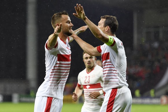 Swiss forward Haris Seferovic, left, celebrates after scoring the goal to the 0:1 with Swiss midfielder Xherdan Shaqiri, center, and Swiss defender Stephan Lichtsteiner, right, during the 2018 Fifa Wo ...