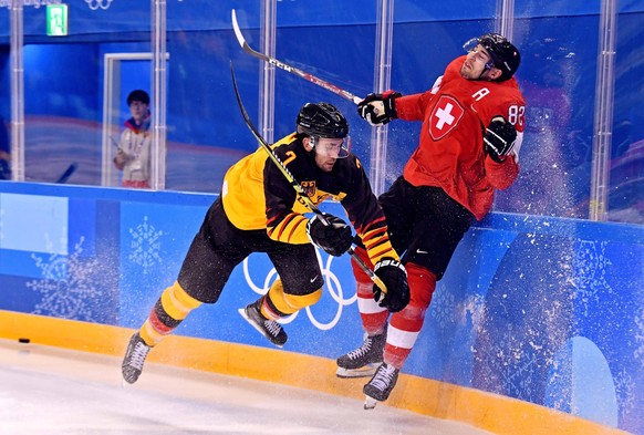 Olympics: Ice hockey, Eishockey Men Team Qualification Match for Quarterfinal - SUI-GER, Feb 20, 2018 Gangneung, South Korea Germany defenseman Daryl Boyle 7 checks Switzerland forward Simon Moser 82  ...