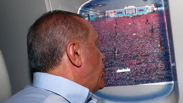 epa06816483 A handout photo made available by the Turkish President Press Office shows Turkish President Recep Tayyip Erdogan looking from helicopter at supporters gathering for an election campaign r ...