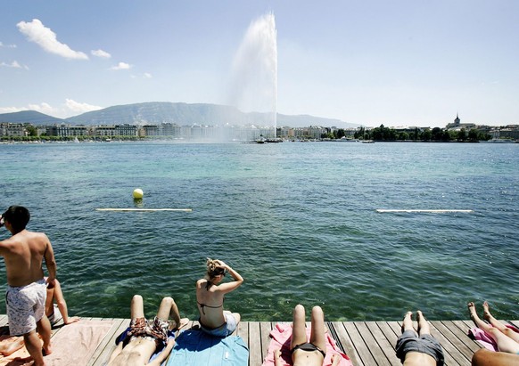 People enjoy warm and sunny weather at the public swimming pool &quot;Bains des Paquis&quot; at the lake of Geneva, in Geneva, Switzerland, Friday, June 20, 2008. (KEYSTONE/Magali Girardin)