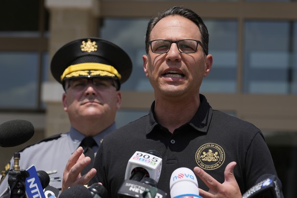 Josh Shapiro, right, governor of Pennsylvania, speaks during a news conference, in Butler, Pa., Sunday, July 14, 2024, concerning the apparent assassination attempt of former President Donald Trump. ( ...