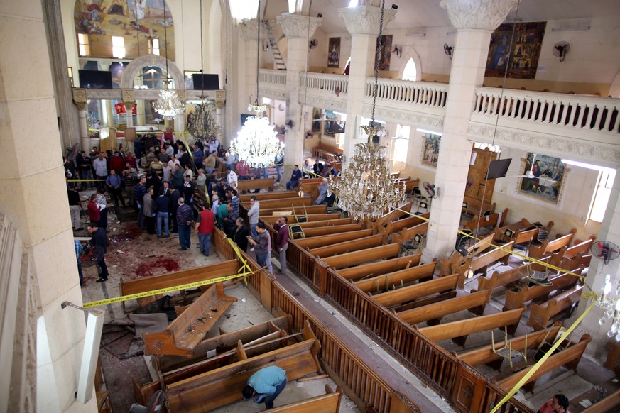 epaselect epa05898868 Security personnel investigate the scene of a bomb explosion inside Mar Girgis church in Tanta, 90km north of Cairo, Egypt, 09 April 2017. According to the Egyptian Health Minist ...