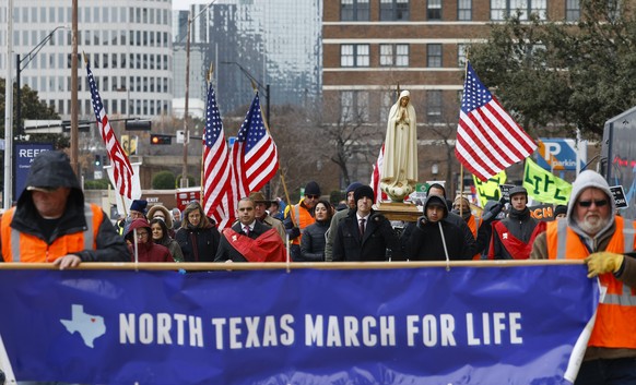 FILE - Protesters walk along Jackson St. during the North Texas March for Life, celebrating the passage and court rulings upholding the Texas law known as Senate Bill 8, on Saturday, Jan. 15, 2022, in ...