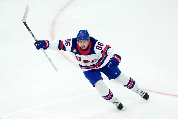 United States' Jack Hughes celebrates after scoring the winning goal against Canada during the overtime period of the men's ice hockey gold medal game at the 2026 Winter Olympics in Milan, I ...