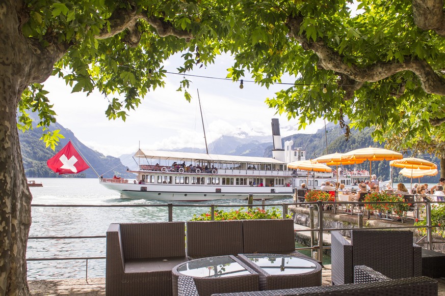 The steamboat Uri navigates to Lucerne on Lake Lucerne near Brunnen, Switzerland on August 12 2014. Due to the current bright weather the open-air restaurant near Lake Lucerne is crowded. (KEYSTONE/Si ...