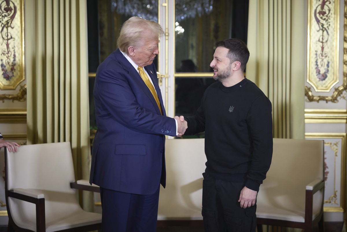 epa11763045 A handout picture made available by the Presidential Press Service of Ukraine shows US President-elect Donald Trump (L), and Ukrainian President Volodymyr Zelensky (R) shaking hands during ...