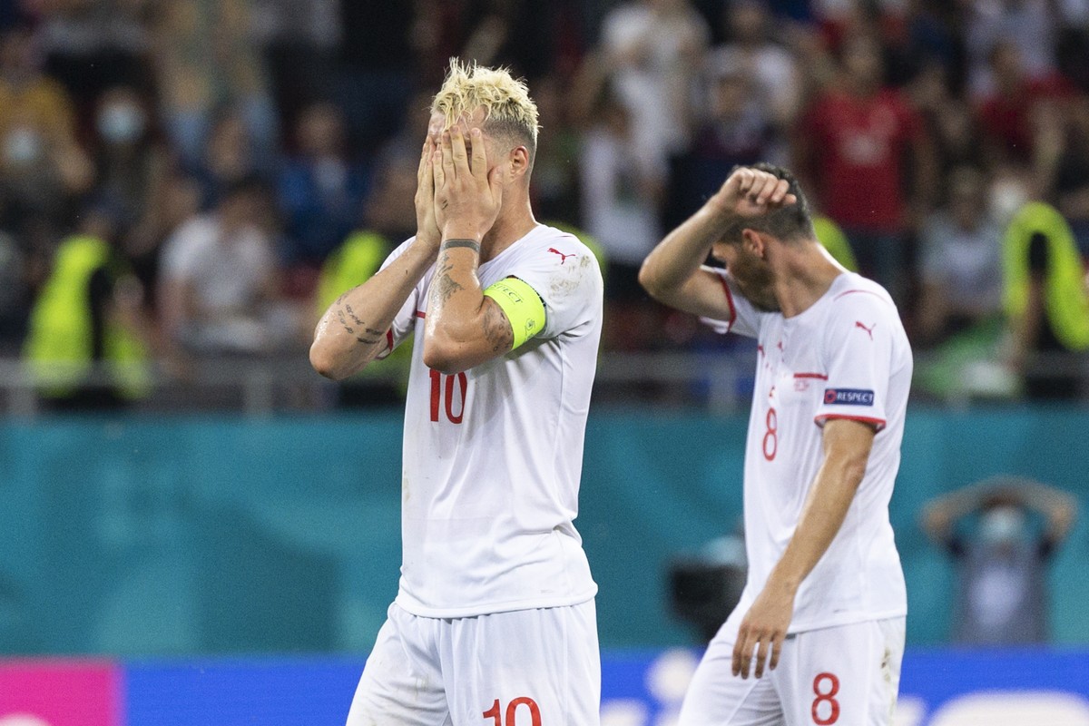 Switzerland's midfielder Granit Xhaka, left, and Remo Freuler react during the Euro 2020 soccer tournament round of 16 match between France and Switzerland at the National Arena stadium, in Bucha ...
