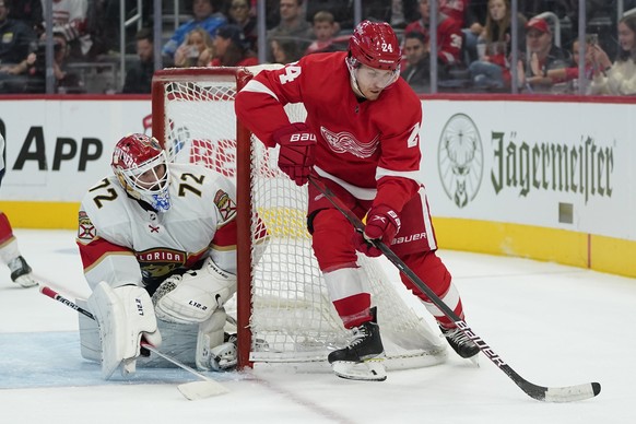 Florida Panthers goaltender Sergei Bobrovsky (72) defends Detroit Red Wings center Pius Suter (24) in the second period of an NHL hockey game Friday, Oct. 29, 2021, in Detroit. (AP Photo/Paul Sancya)