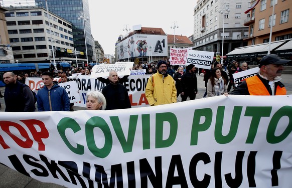 epa09085596 Peopl protest against restrictions put in place by governments to stop COVID-19 coronavirus pandemic in Zagreb, Croatia, 20 March 2021. Similar protests were held in other Croatian cities  ...