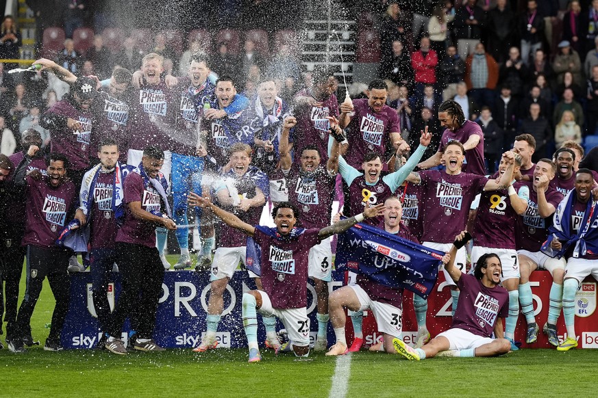 Burnley players celebrate their promotion to the English Premier League after the Championship soccer match against Sheffield United at Turf Moor, Burnley, England, Monday April 21, 2025. (Nick Potts/ ...
