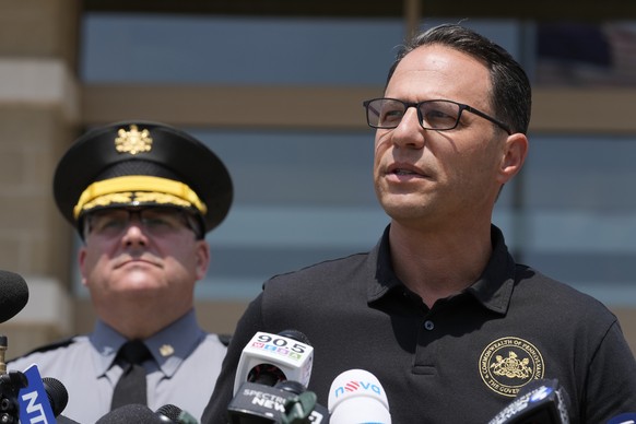 Josh Shapiro, right, governor of Pennsylvania, speaks during a news conference, in Butler, Pa., Sunday, July 14, 2024, concerning the apparent assassination attempt of former President Donald Trump. ( ...