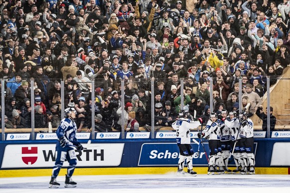 Fribourg players celebrate the 3:1 in front of their fans during the final game between Germany's Straubing Tigers and Switzerland's HC Fribourg-Gotteron at the 96th Spengler Cup ice hockey  ...