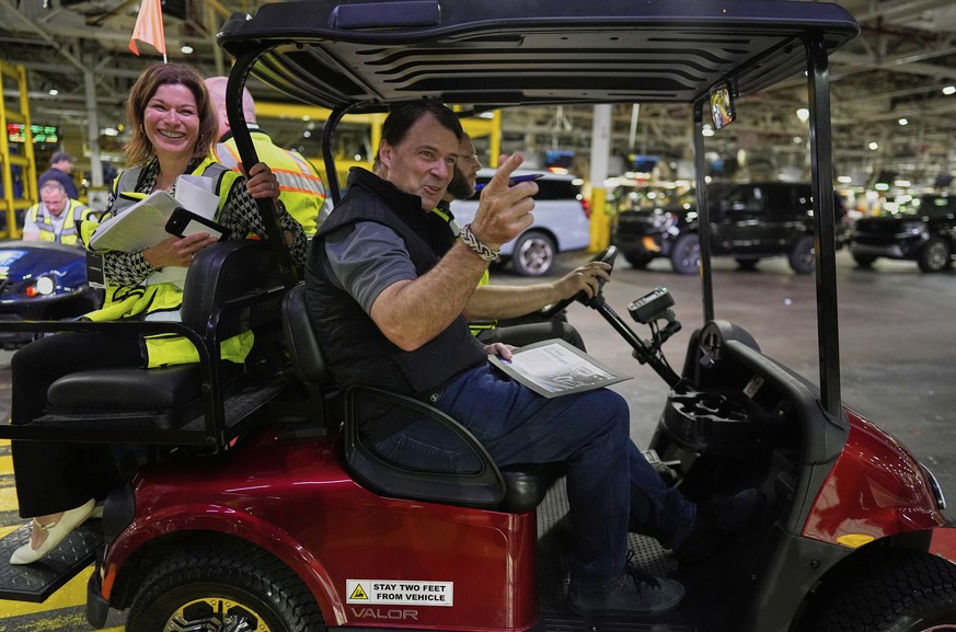 Jim Farley, President and Chief Executive Officer of Ford, right, looks to employees as he leaves after speaking at the Ford Motor Company Kentucky Truck Plant to launch the 2025 Ford Expedition, Wedn ...