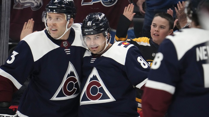 Colorado Avalanche defenseman Jack Johnson, left, congratulates center Denis Malgin after he scored a goal against the Arizona Coyotes in the first period of an NHL hockey game, Saturday, March 11, 20 ...