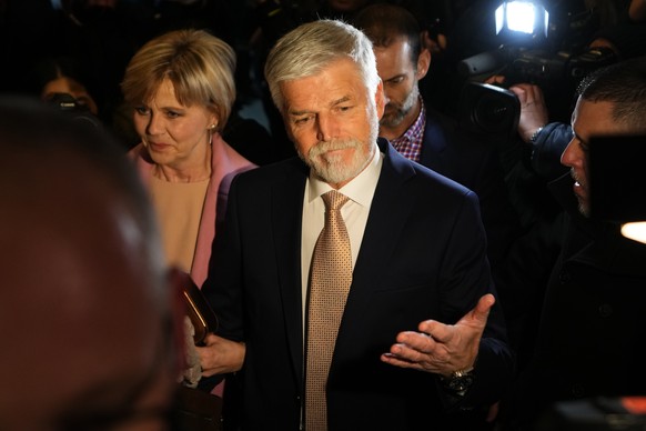 Presidential candidate and retired army Gen. Petr Pavel with his wive Eva arrives at his election headquarters to acknowledge the preliminary results of the presidential runoff in Prague, Czech Republ ...