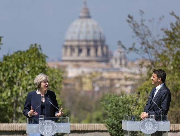 Italian Premier Matteo Renzi, right, listens to British Prime Minister Theresa May during a joint press conference at the end of their meeting in Rome Wednesday, July 27, 2016. In the background Rome& ...