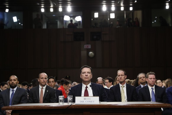 Former FBI director James Comey listens to the committee chairman at the beginning of the Senate Intelligence Committee hearing on Capitol Hill, Thursday, June 8, 2017, in Washington. (AP Photo/Alex B ...