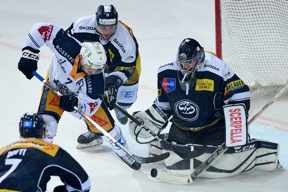 Zug's player David McIntyre, Ambri's player Marco Mueller and Ambri's goalkeeper Benjamin Conz, from left, during a qualification game of the National League between HC Ambrì Piotta and ...