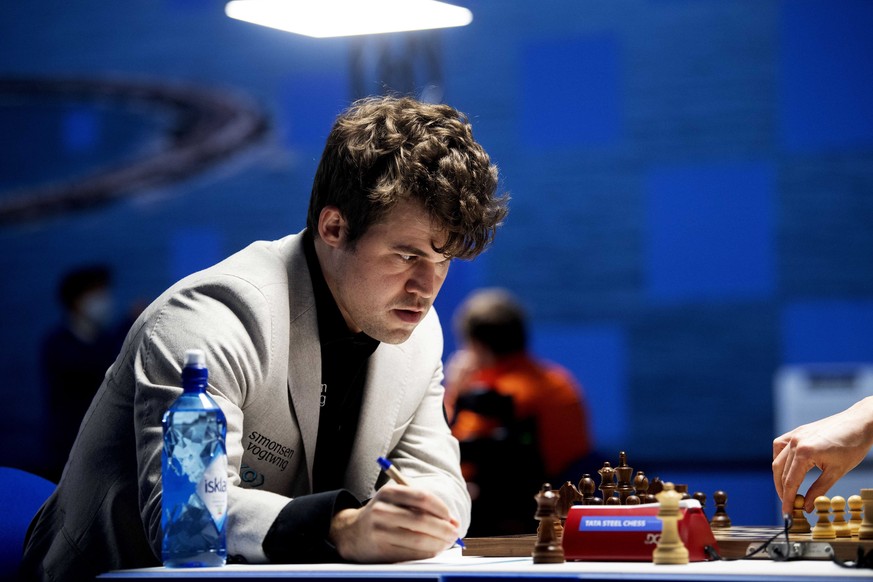 epa09716777 Norwegian World Chess Champion Magnus Carlsen contemplates his next move during the last weekend of the 84th Tata Steel Masters Chess tournament in Wijk aan Zee, The Netherlands, 29 Januar ...