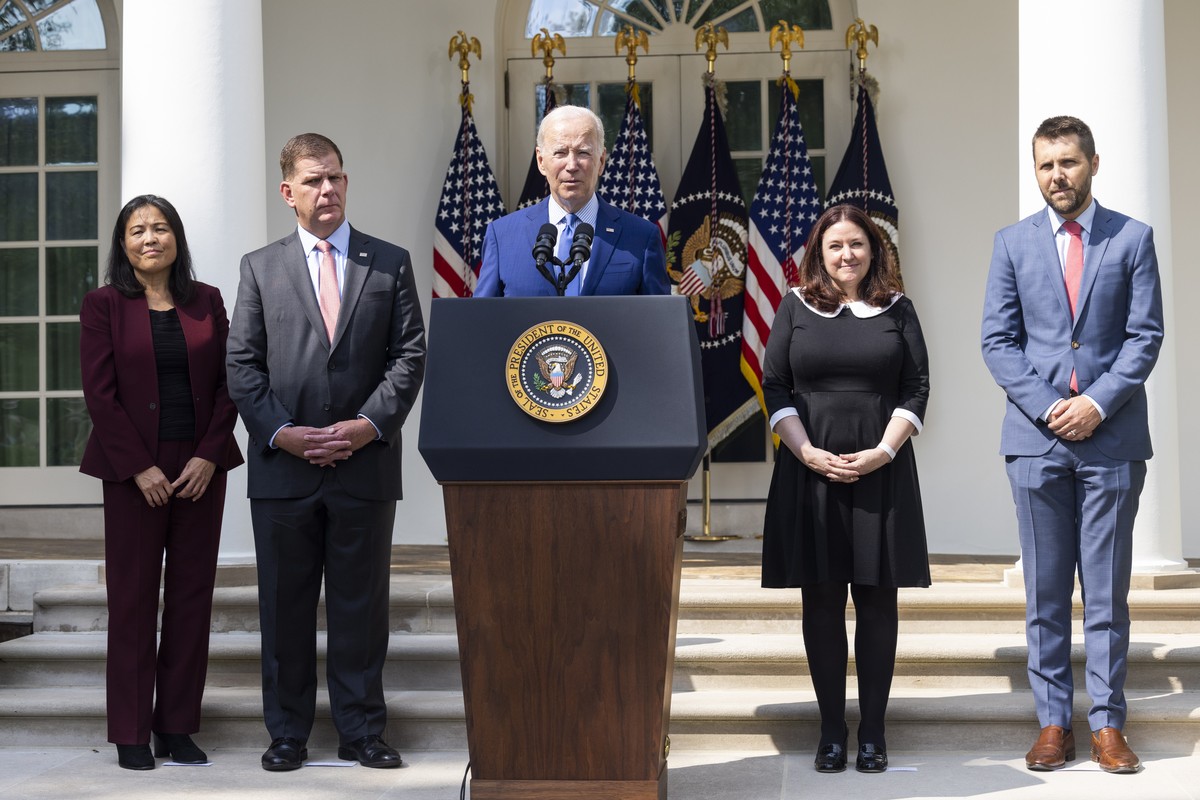 epa10185975 US President Joe Biden (C), along with Deputy Secretary of Labor Julie Su (L), Labor Secretary Marty Walsh (C-L), Director of Made in America at the Office of Management and Budget, Celest ...