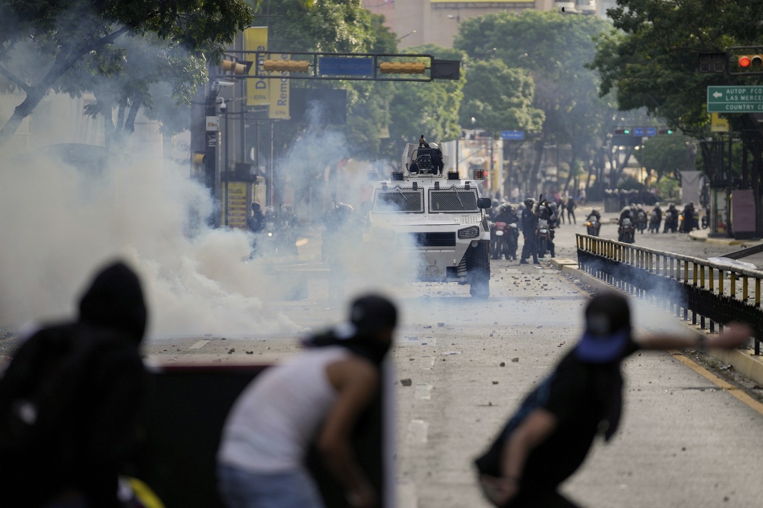 FILE - Protesters clash with police during demonstrations against the official election results declaring President Nicolas Maduro&#039;s reelection, the day after the vote in Caracas, Venezuela, July ...