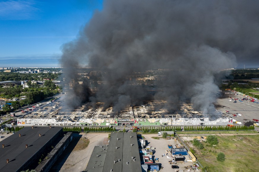 epa11334629 General view of a fire in a shopping complex in Warsaw, Poland, 12 May 2024. Nearly 100% of Marywilska 44 was destroyed in the fire, one of the biggest shopping centers in Warsaw with almo ...