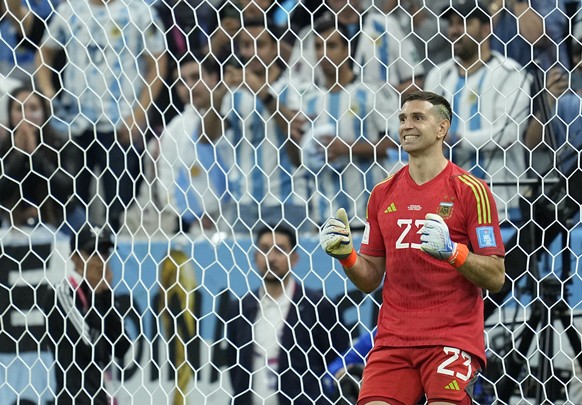 Argentina&#039;s goalkeeper Emiliano Martinez smiles during the penalty shootout in the World Cup quarterfinal soccer match between the Netherlands and Argentina, at the Lusail Stadium in Lusail, Qata ...