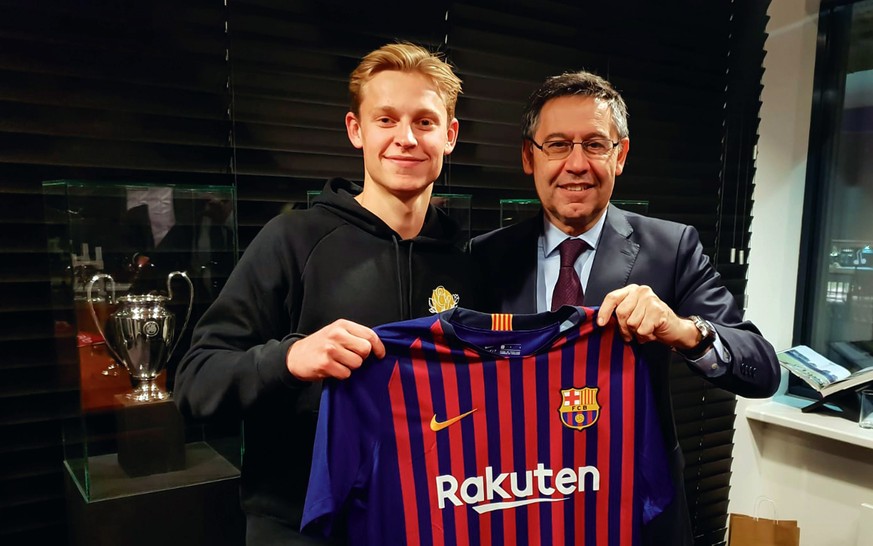 epa07312861 A handout picture provided by FC Barcelona shows FC Barcelona's president, Josep Maria Bartomeu (R) posing for the photographers with Dutch soccer player Frenkie de Jong (L) in Amster ...