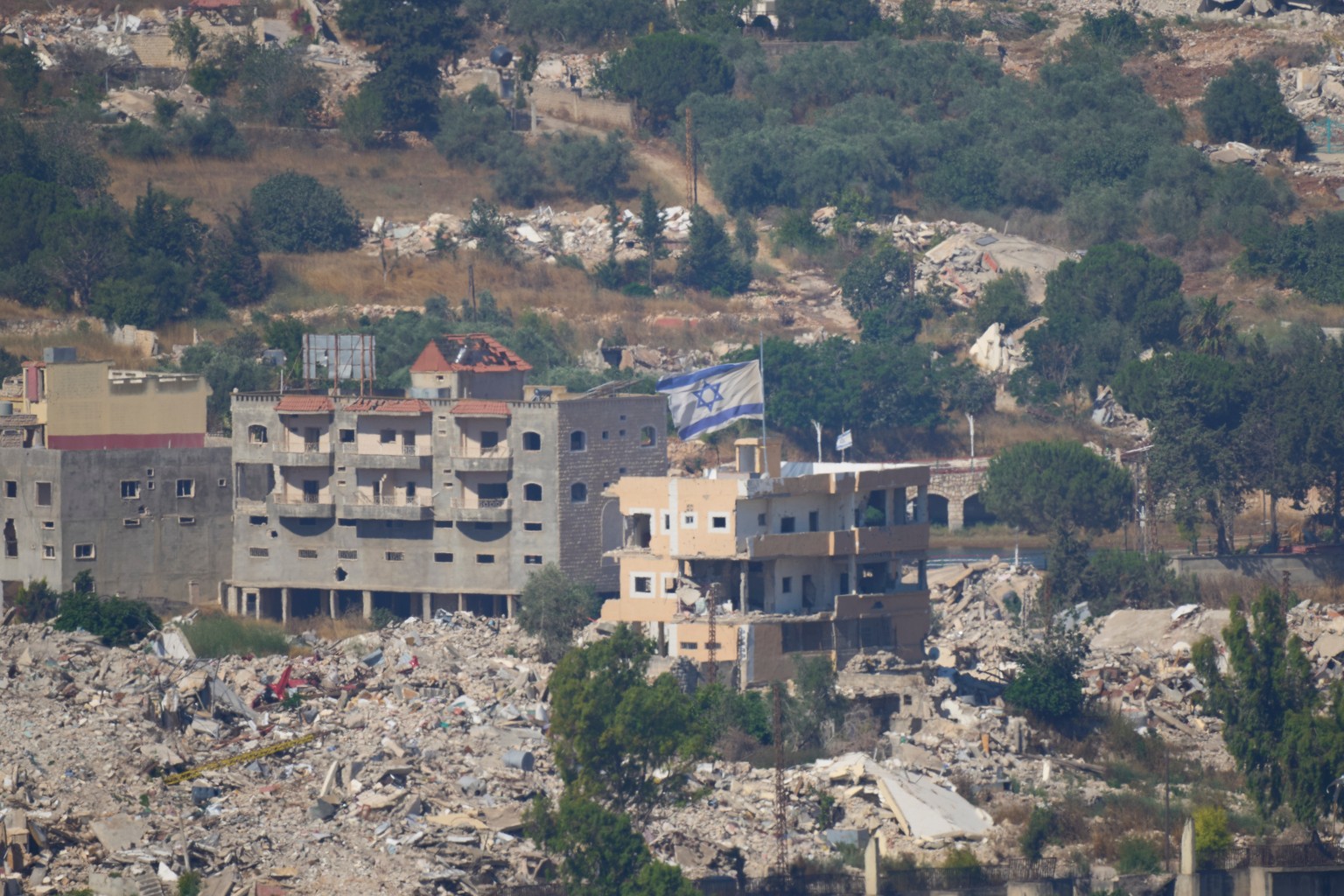 An Israeli flag tops a destroyed building in southern Lebanon, as seen from northern Israel, Sunday, June 28, 2026. (AP Photo/Ohad Zwigenberg)
Israel Lebanon Iran War